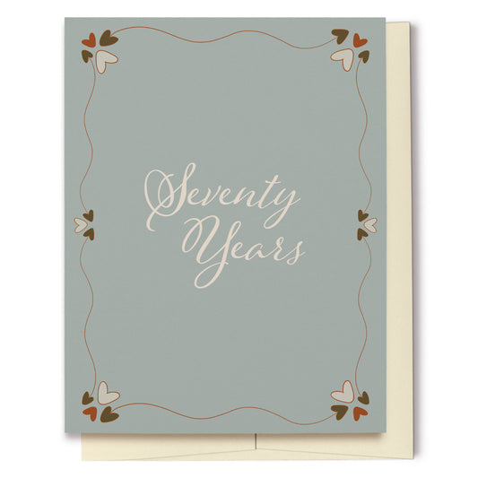 Whether for a birthday or anniversary, this card featuring a dusty teal background with decorative hearts, is perfect for celebrating Seventy Years!