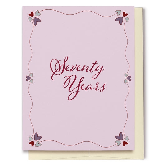 Whether for a birthday or anniversary, this card featuring a pink background with decorative hearts, is perfect for celebrating Seventy Years!