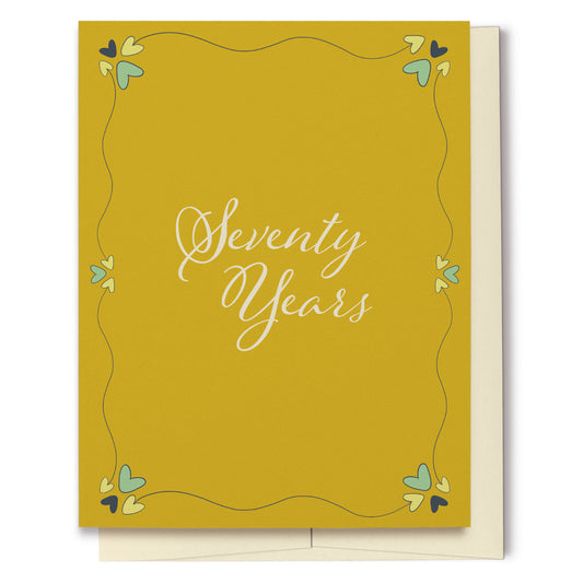 Whether for a birthday or anniversary, this card featuring a mustard yellow background with decorative hearts, is perfect for celebrating Seventy Years!