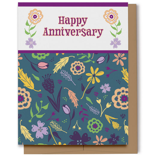 Floral patterned card featuring deep teal background with shades of purple, magenta, yellow, green, and peach, which reads, "Happy Anniversary".